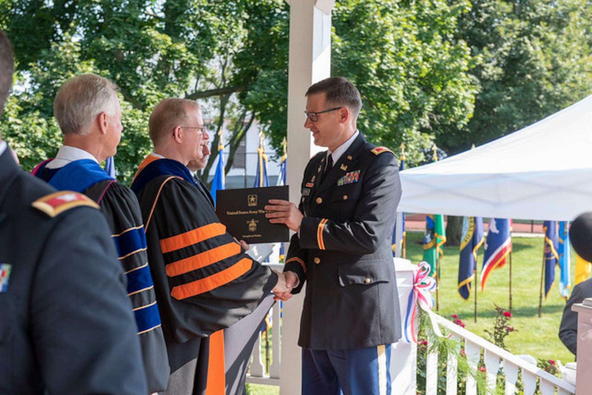 U.S. Army Reserve Col. Aaron Justice, commander of the 510th Regional Support Group, 7th Mission Support Command, receives his diploma during the U.S. Army War College class of 2019 graduation ceremony on Carlisle Barracks, Pennsylvania, July 26, 2019. Five 7th MSC officers graduated the two-year program with a Master's degree in Strategic Studies.