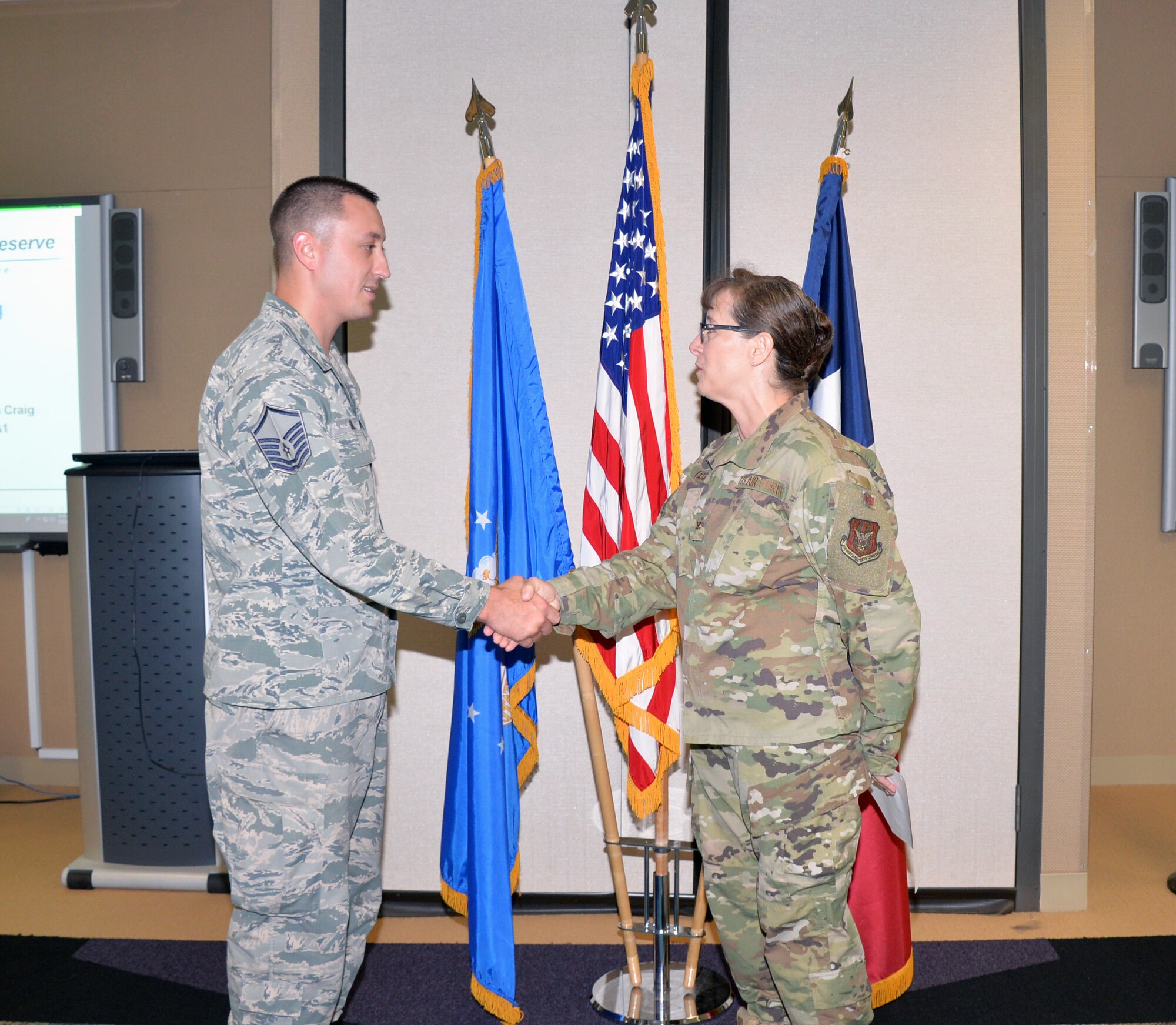 Col. Lisa M. Craig, Air Force Reserve Command director of manpower, personnel, and services, presents a coin to Master Sgt. Brian Boblett, 433rd Force Support Squadron family readiness NCO, Aug 3, 2019 at Joint Base San Antonio-Lackland, Texas.