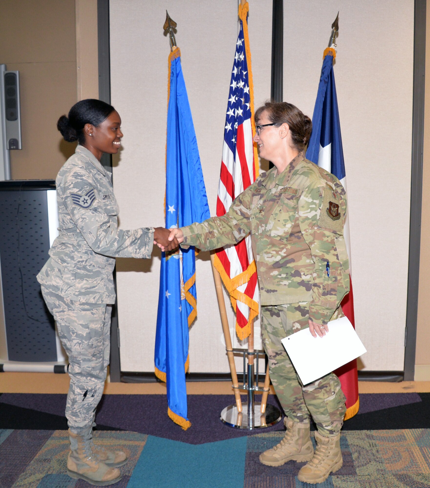 Col. Lisa M. Craig, Air Force Reserve Command director of manpower, personnel, and services, presents a coin to Staff Sgt. Chelsea Smith, 433rd Force Support Squadron sustainment specialst, Aug 3, 2019 at Joint Base San Antonio-Lackland, Texas.