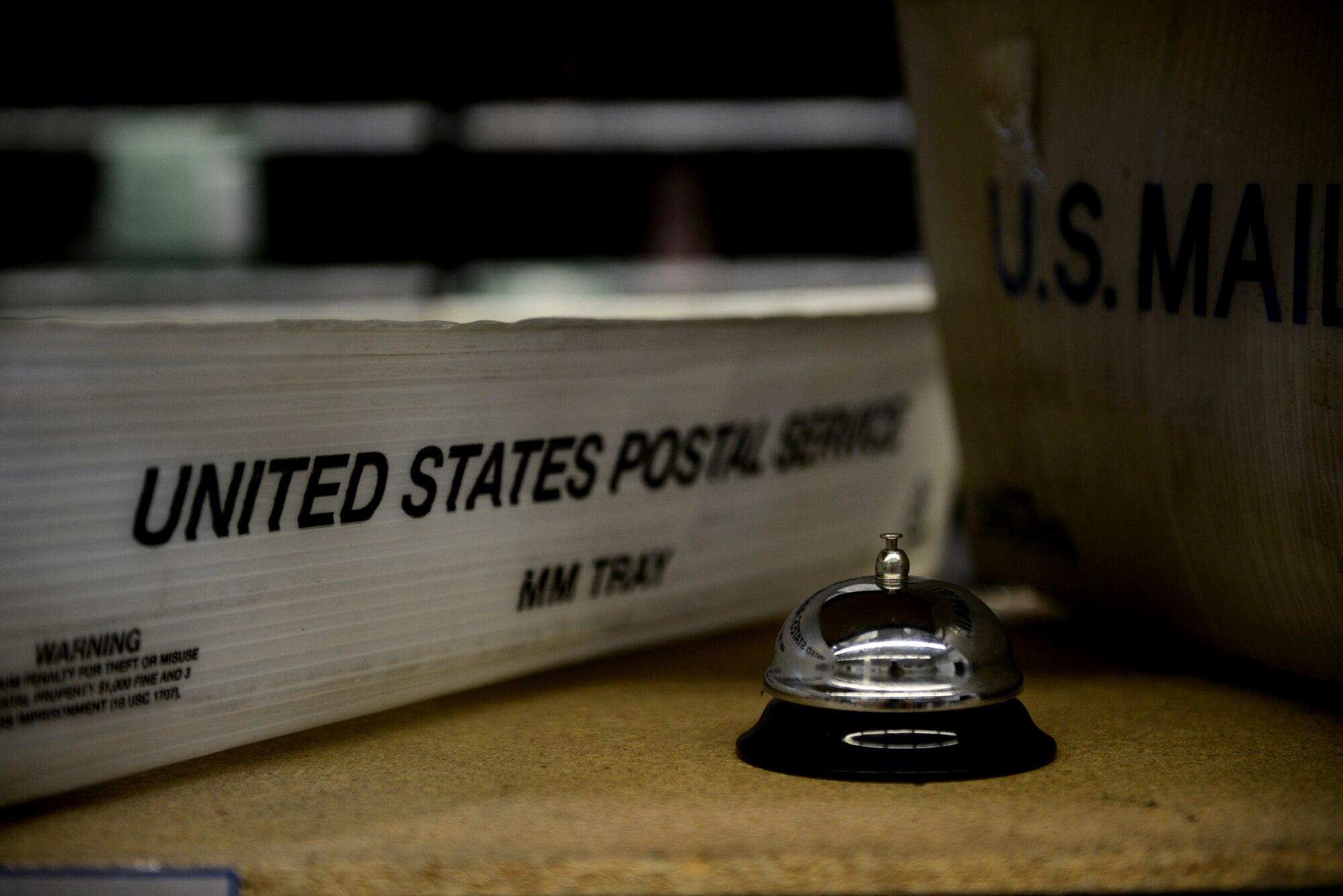 A call bell sits next to two United States postal service trays for help and service from the military postal clerks from the 31st Force Support Squadron Aug. 1, 2019, at Aviano Air Base, Italy. The 31st Force Support Squadron is the 31st Fighter Wing's largest and most diverse squadron, comprised of more than 600 military and civilian personnel whose primary mission is to enhance combat capability, readiness, and quality of life for a community of nearly 10,000 military members, DoD civilians, local national employees, and dependents. (U.S. Air Force photo by Airman 1st Class Ericka A. Woolever)