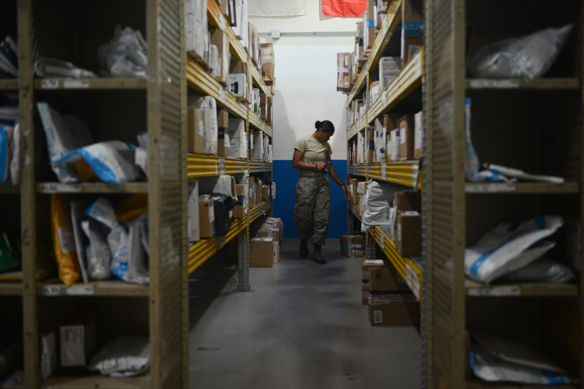 Airman 1st Class Mafaolo Tafaovale, a military postal clerk from the 31st Force Support Squadron, locates a customer’s package, Aug. 1, 2019, at Aviano Air Base, Italy. Tafaovale improved the community’s quality of life and service by helping customers with their packages. (U.S. Air Force photo by Airman 1st Class Ericka A. Woolever)