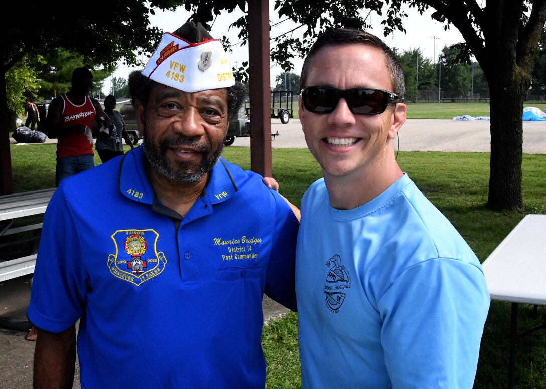 At right, one of the 932nd Airlift Wing's 73rd Airlift Squadron pilots and commander of the squadron, Lt. Col. Brandon Lorton, takes time out at the end of the warm summer wing picnic to thank Veterans of Foreign Wars past District 14 commander, Maurice Bridges, who volunteered to help the unit during their annual picnic held August 3, 2019, at Scott Air Force Base, Illinois.  The day's event featured food, volleyball, softball competition (won by the enlisted team), face painting, and a dunk tank. (U.S. Air Force photo by Lt. Col. Stan Paregien)