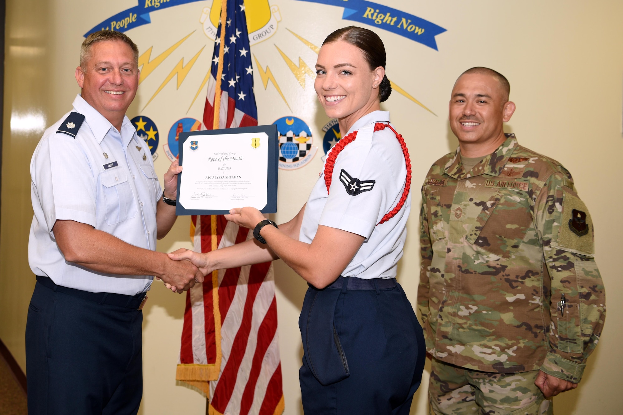 U.S. Air Force Lt. Col. Herbert Millet III, 313th Training Squadron commander, presents the 312th Training Squadron Student of the Month award to Airman 1st Class Alyssa Sheahan, 312th TRS student, at the Brandenburg Hall on Goodfellow Air Force Base, Texas, August 2, 2019. The 312th TRS’s mission is to provide Department of Defense and international customers with mission ready fire protection and special instruments graduates and provides mission support for the Air Force Technical Applications Center. (U.S. Air Force photo by Airman 1st Class Abbey Rieves/Released)