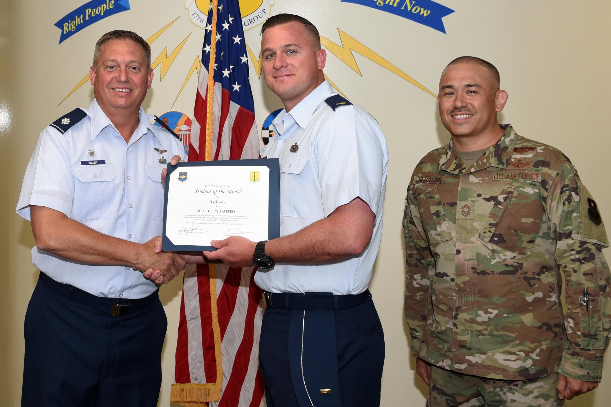 U.S. Air Force Lt. Col. Herbert Millet III, 313th Training Squadron commander, presents the 315th Training Squadron Officer Student of the Month award to 2nd Lt. Cory Maffeo, 315th TRS student, at the Brandenburg Hall on Goodfellow Air Force Base, Texas, August 2, 2019. The 315th TRS’s vision is to develop combat-ready intelligence, surveillance and reconnaissance professionals and promote an innovative squadron culture and identity unmatched across the U.S. Air Force. (U.S. Air Force photo by Airman 1st Class Abbey Rieves/Released)