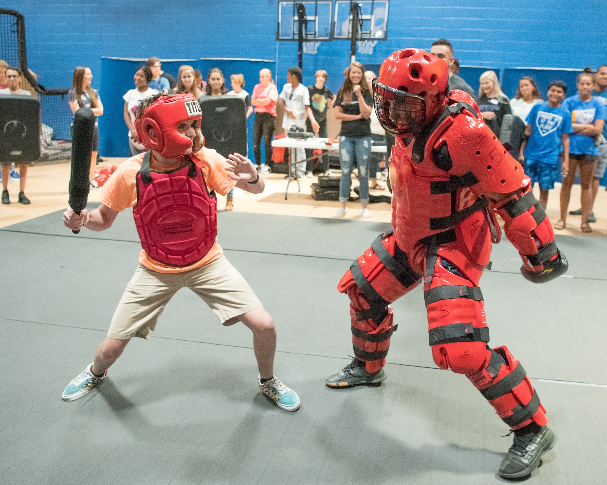 Senior Airman John Paul C. Zografos, 436th Security Forces Squadron Raven, wears a “Red Man” suit during a sparring session against a Caesar Rodney High School freshman June 31, 2019, at Caesar Rodney High School in Camden, Del. Over 30 Dover AFB Airmen visited the school to share their Air Force career experiences and teach the students skills to help them excel in the workplace. (U.S. Air Force photo by Mauricio Campino)