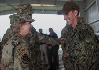 Gen. Maryanne Miller, left, commander of Air Mobility Command, coins a Sailor during a visit to Joint Base Charleston Naval Weapons Station, South Carolina, July 30, 2019. Miller visited JB Charleston July 29 to August 1 to get a first-hand look at mission capabilities, new innovative programs and how JB Charleston is taking care of its service members to build a stronger mobility force. Joint Base Charleston is one of 12 Department of Defense Joint Bases and host to over 60 DOD and Federal agencies. Naval Munitions Command provides quality and responsible ordnance material handling, and technical and material support to the Fleet and other customers in the areas of retail ammunition management. The command also maintains and operate explosive ordnance outboarding and transshipment facilities.