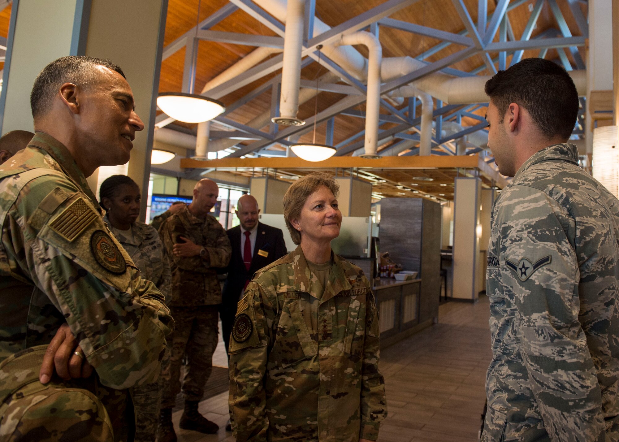 Airman Skyler Locklear, right, assigned to the 628th Force Support Squadron, meets Gen. Maryanne Miller, center, commander of Air Mobility Command, and Chief Master Sgt. Terrence Greene, AMC command chief master sergeant, during a tour of the Gaylor Dining Facility at Joint Base Charleston, South Carolina, July 30, 2019. Miller and Greene visited JB Charleston July 29 to August 1 to get a first-hand look at mission capabilities, new innovative programs and how JB Charleston is taking care of its service members to build a stronger mobility force.  The dining facility re-opened February 2019 after a two-year renovation. The renovations help dining facility personnel adjust to changing dietary needs and preferences, and improves efficiency and reduces costs while maintaining mission feeding capabilities.