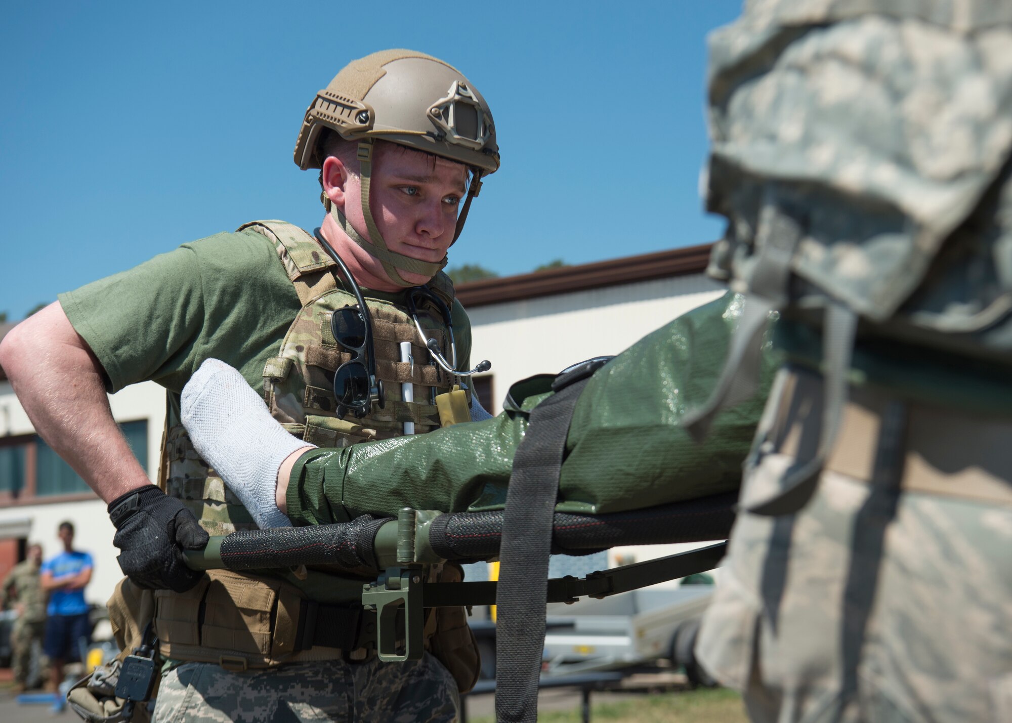 A medic lifts a training victim into a Humvee at Ramstein Air Base, Germany, July 23, 2019. Participants of the U.S. Air Forces in Europe EMT Rodeo had to use not only their skills but their physical and mental strength for these challenges. (U.S. Air Force photo by Staff Sgt. Kirby Turbak)