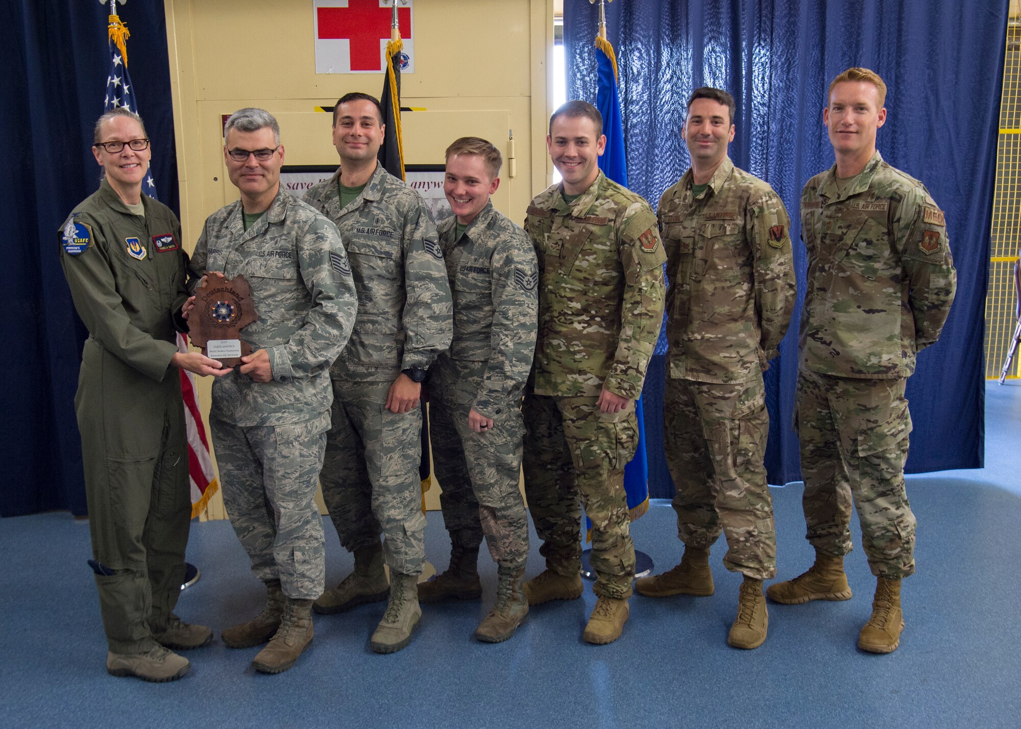 Members of the 48th Medical Group from Royal Air Base Lakenheath, England receive the U.S. Air Forces in Europe EMT Rodeo trophy at Ramstein Air Base, Germany, July 25, 2019. Teams were judged on how accurate and quickly they provided medical attention. (U.S. Air Force photo by Staff Sgt. Kirby Turbak)