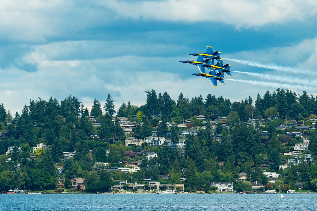 Planes fly in formation.