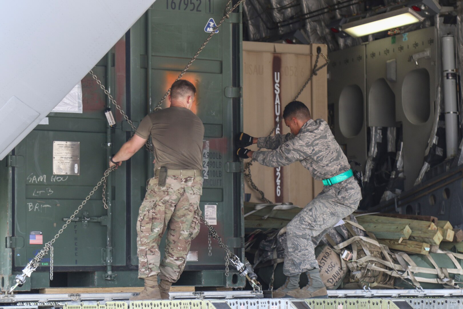 A Soldier with Task Force-51 and an Airman with the 502nd Logistics Readiness Squadron load equipment on a C-17 Globemaster III cargo plane in preparation to support exercise Vigilant Guard-Ohio at Joint Base San Antonio-Kelly Field Annex in San Antonio Aug 4. VG-Ohio is held by U.S. Northern Command and the National Guard Bureau that will test the state's emergency response capabilities with a simulated attack.