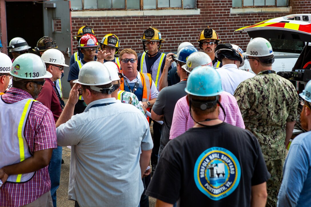City of Chesapeake firefighters tour USS George H.W. Bush (CVN 77) at Norfolk Naval Shipyard (NNSY) July 25, helping to better understand the shipyard’s waterfront layout, emergency scene operations and carrier confines in the event of a major fire shipboard.  Bush is currently at NNSY undergoing a Drydocking Planned Incremental Availability (DPIA).