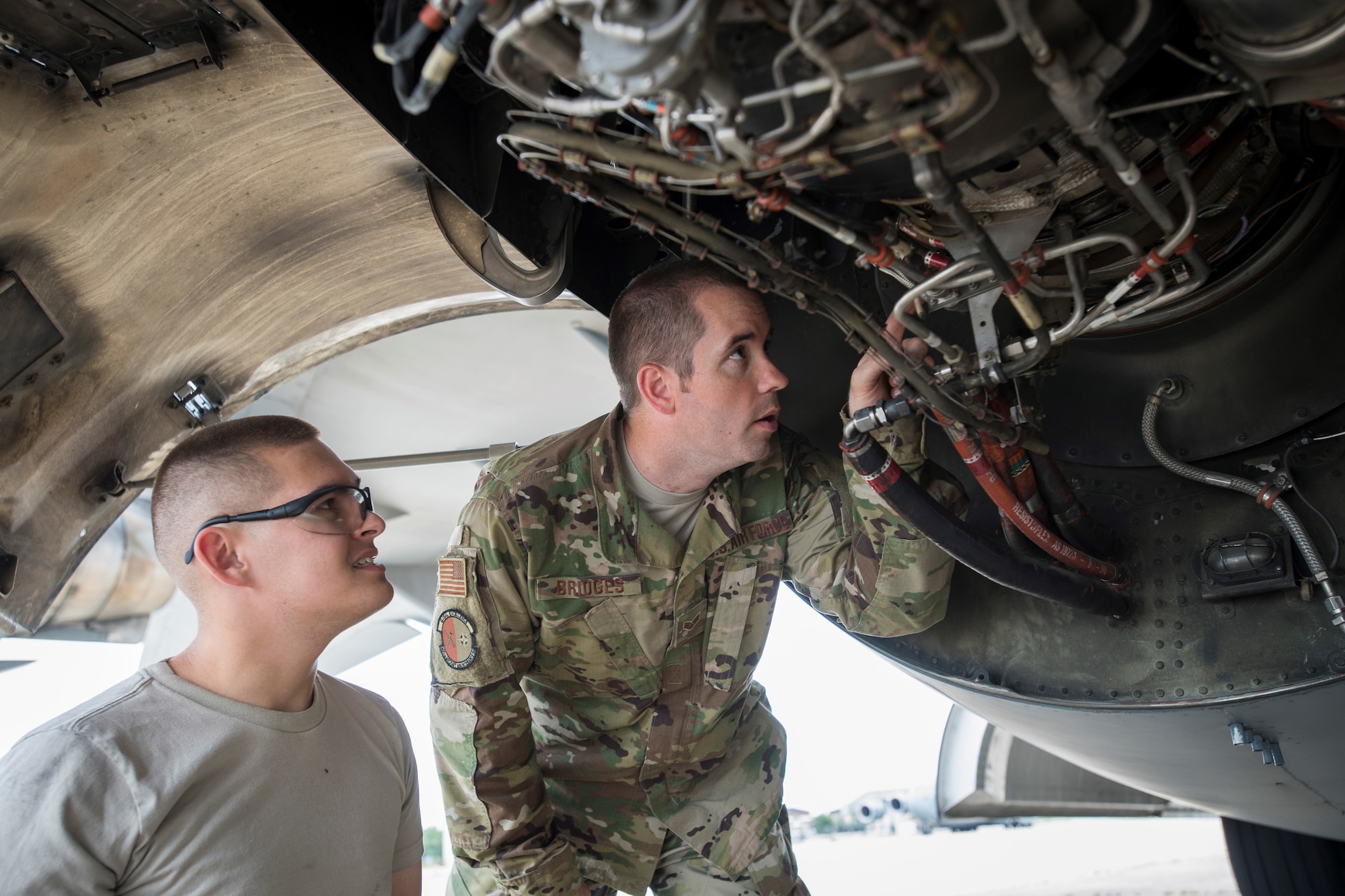 U.S. Air Force Senior Airman Joshua Bridges and U.S. Air Force Airman 1st Class Nathaniel Canfield, 305th Aircraft Maintenance Squadron jet engine mechanics, troubleshoot a part inside of a C-17 Globemaster engine during maintenance checks August 2, 2019 on Joint Base McGuire-Dix-Lakehurst, New Jersey. Responsible for ensuring that all plane’s engines are in first-rate operational conditions, jet engine mechanics test, maintain and repair all parts of the engine. (U.S. Air Force photo by Senior Airman Jake Carter)