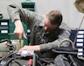 U.S. Army Sgt. Andrew Trent, a wheeled vehicle mechanic, Headquarters and Headquarters Company, 4th Special Troops Battalion, 4th Sustainment Brigade tightens a hose on a HUMVEE 7