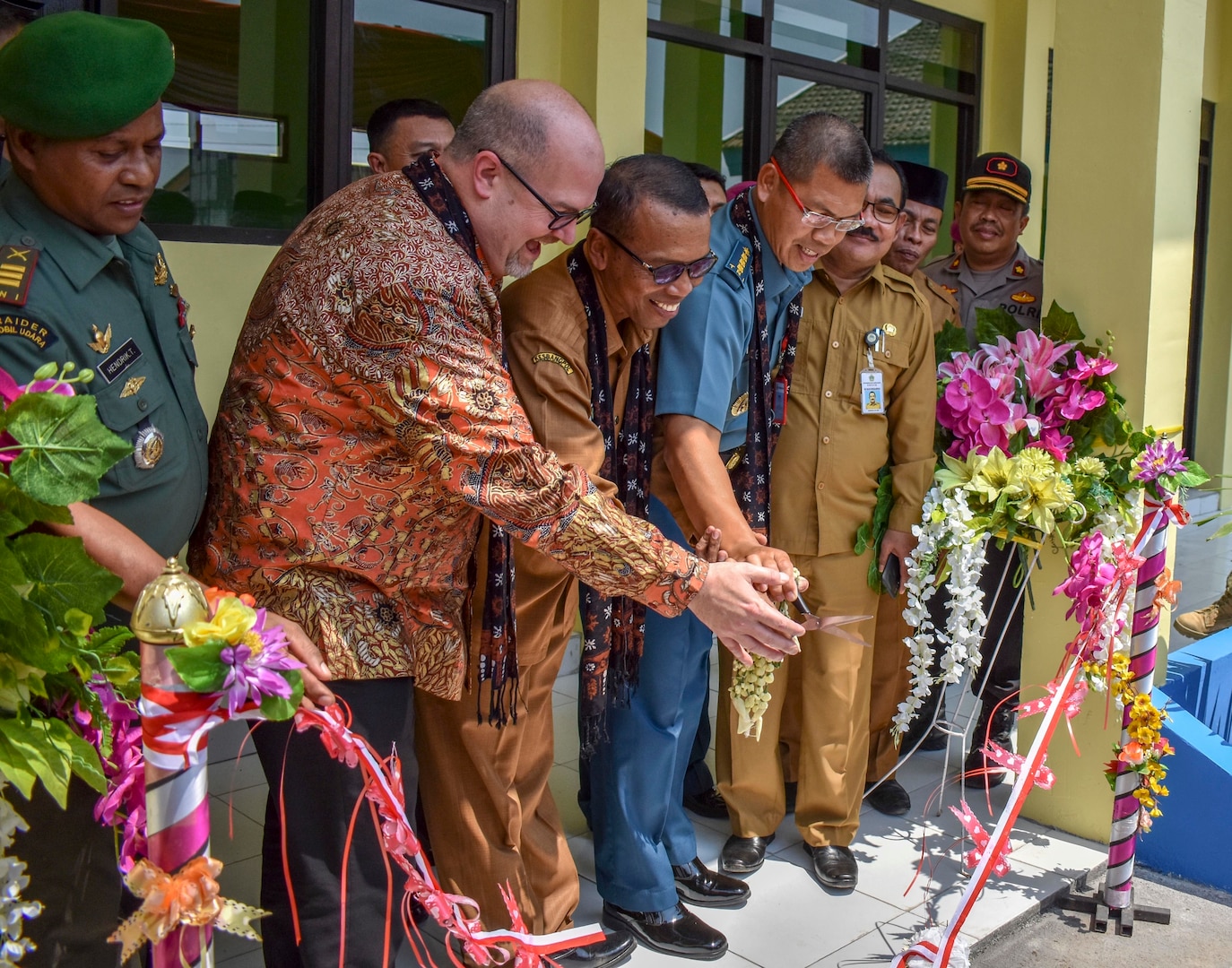 GRESIK DISTRICT, Indonesia (Aug. 5, 2019) Mark McGovern, U.S. Consul General in Surabaya, Indonesia, Dr. Sambari Halim Radianto, head of Gresik District Government, and Indonesian Navy Kolonel Laut Eka Prabawa, assistant for maritime potential, cut a ribbon to mark the completion of a construction project at the SDN Duduk Sampeyan Elementary School during Cooperation Afloat Readiness and Training (CARAT) Indonesia 2019. During the project, U.S. Navy Seabees assigned to Naval Mobile Construction Battalion 4 and Indonesian Marines assigned to the 2nd Engineering Battalion built a two-room classroom wired to support 20 computers. This year marks the 25th iteration of CARAT, a multinational exercise designed to enhance U.S. and partner navies' abilities to operate together in response to traditional and non-traditional maritime security challenges in the Indo-Pacific region. (U.S. Navy photo by Steelworker 2nd Class Candace Lightsey)