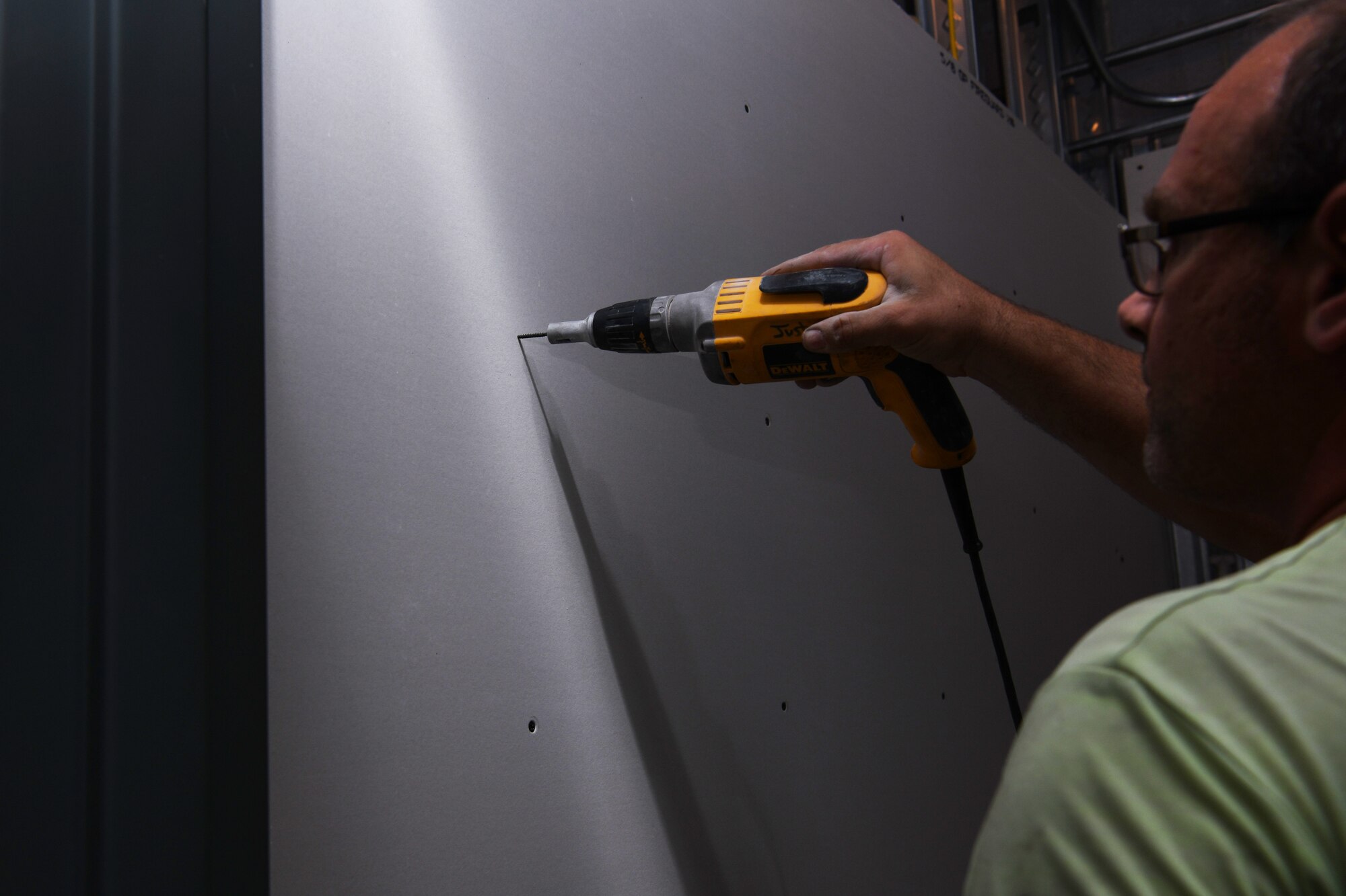 A construction worker with Horst Construction secures drywall at the Ellsworth Air Force Base Veterinarian Treatment Facility at Ellsworth AFB, S.D., July 30, 2019. The clinic is adding a new MWD procedure room where the clinic team can focus on their care, while simultaneously seeing pets of service members in their new exam rooms. (U.S. Air Force photo by Airman Quentin K. Marx)