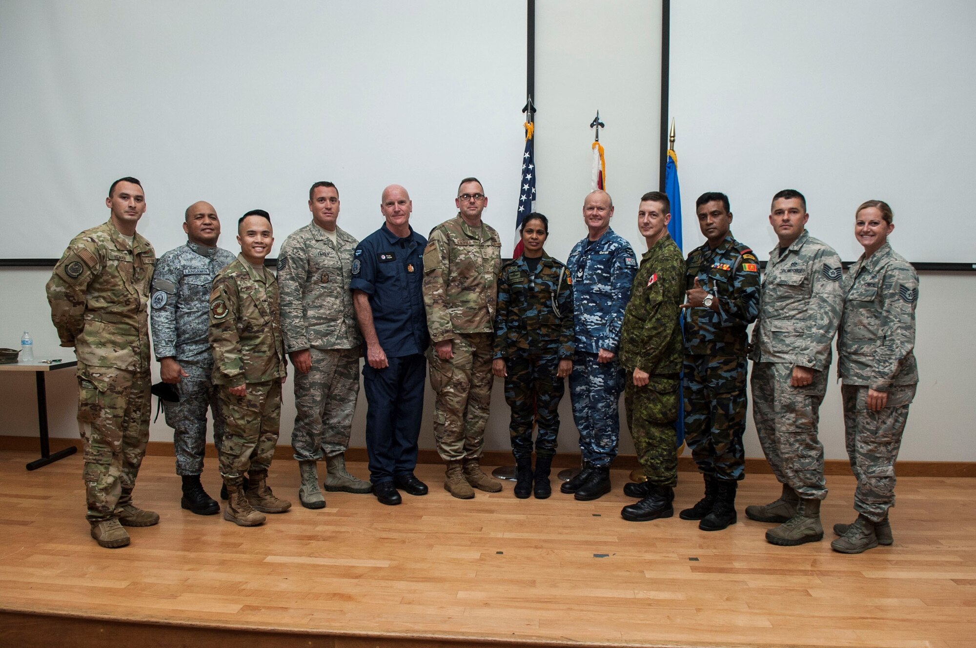 U.S. Air Force Airmen pose for a picture with international service members during a First Sergeants Symposium at Joint Base Pearl Harbor-Hickam, Hawaii, July 24, 2019. The five-day course included training provided by Air University, the First Sergeant Academy, and informational briefings from base helping agencies. Service members from Sri Lanka, Australia, New Zealand, and the Philippines participated in the symposium. (U.S. Air Force photo by Staff Sgt. Mikaley Kline)