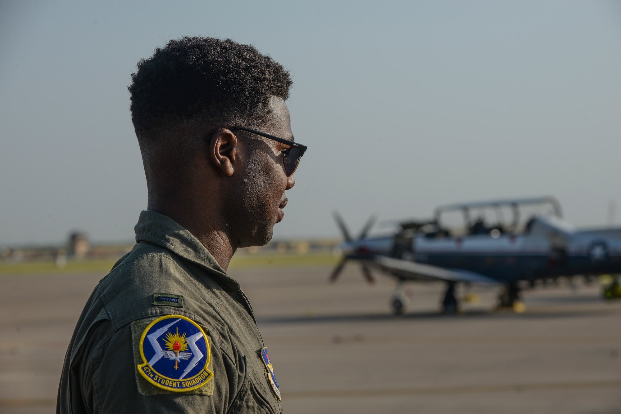 47th Flying Training Wing Class 19-17 graduate and Order of Daedalians AETC Commander’s Trophy recipient, 1st Lt. Tyler Weaver, glances at the T-6 fleet, an aircraft he initially flew during Phase II of pilot training at Laughlin Air Force Base, Texas, July 31, 2019. During each phase of pilot training, students are expected to study, work collaboratively, and seek mentorship from their instructors and senior rated commanders. U.S. Air Force photo by Capt. Mahalia Frost)