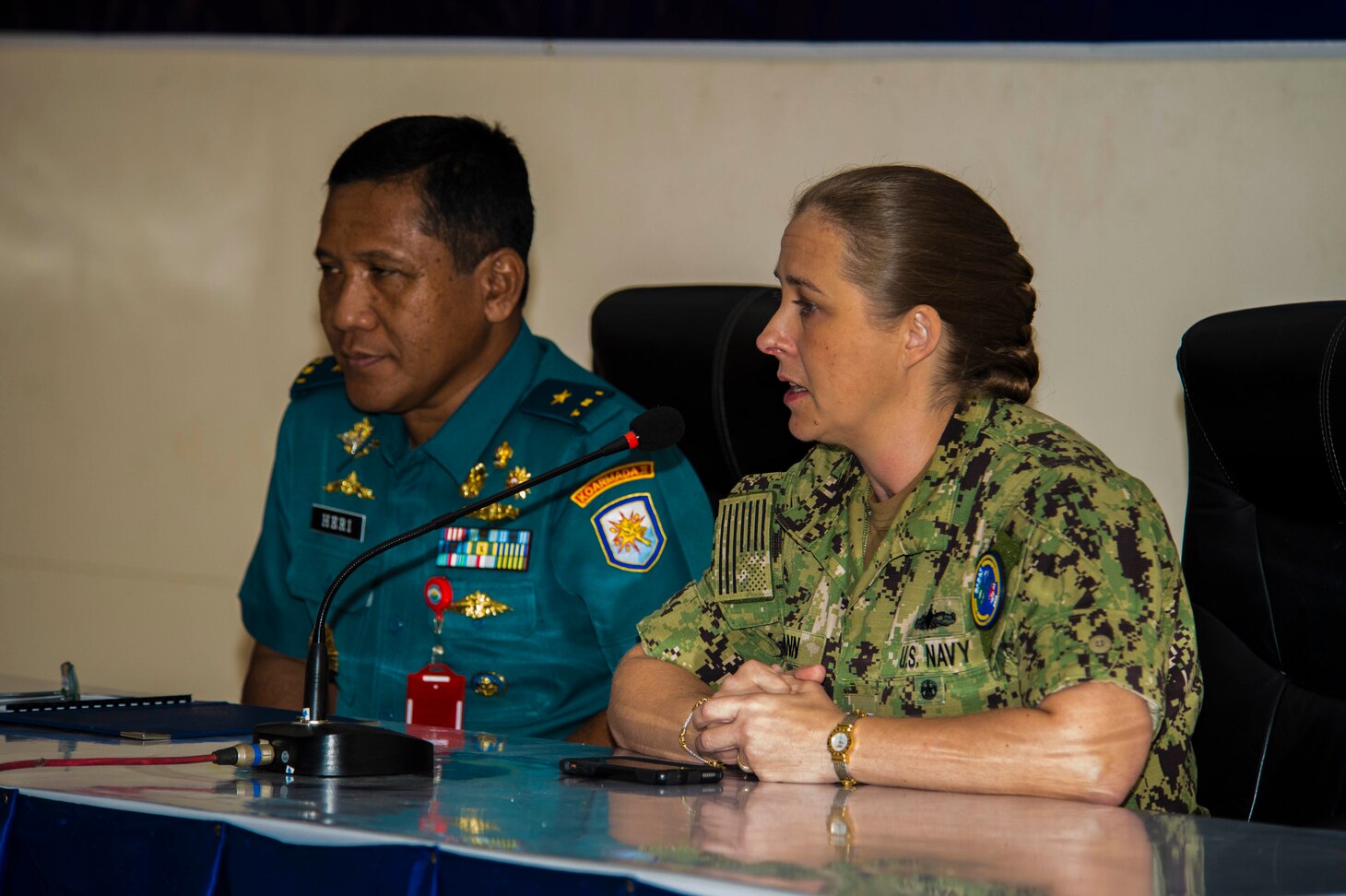 JAVA SEA (August 7, 2019) U.S. Navy Capt. Ann McCann, deputy commodore of Commander, Destroyer Squadron 7, and Indonesian Navy First Adm. Ahmadi Heri Purwono, chief of staff, 2nd Fleet Command provide their closing remarks during the closing ceremony of Cooperation Afloat Readiness and Training (CARAT) Indonesia 2019. CARAT, the U.S. Navy's longest running regional exercise in South and Southeast Asia, strengthens partnerships between regional navies and enhances maritime security cooperation throughout the Indo-Pacific.