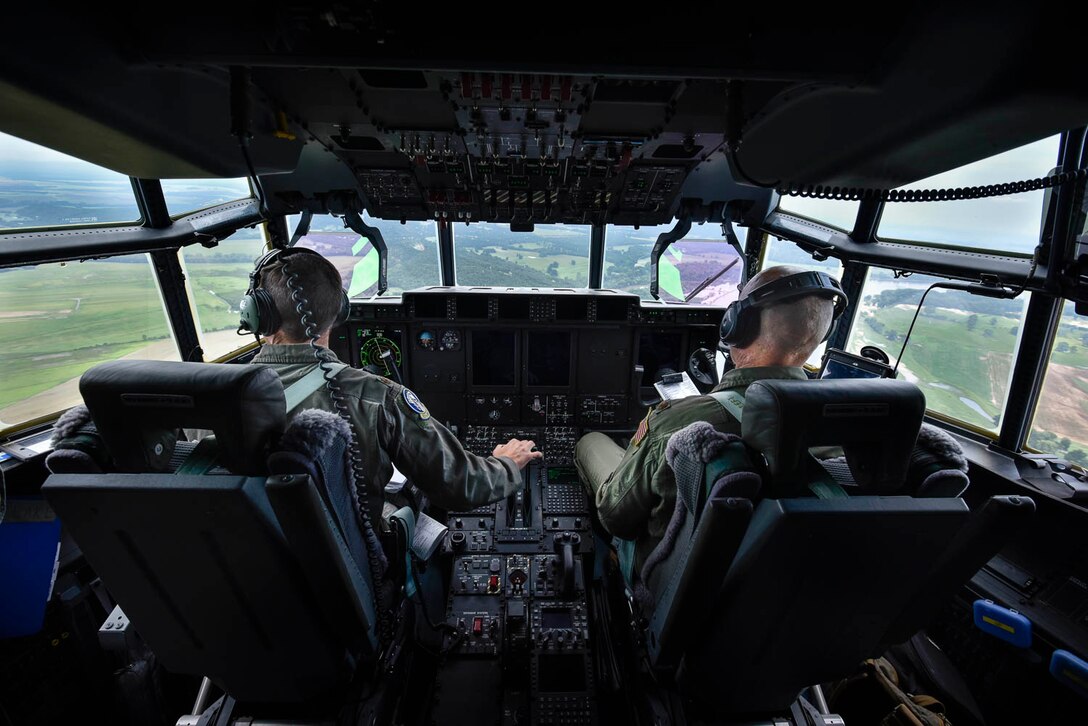 Maj. Seth Lake, 327th Airlift Squadron pilot, and Maj. Maj. Matthew Heisel, 327th Airlift Squadron pilot, participate in a training flight to enhance readiness on August 3, 2019, at Little Rock Air Force Base, Ark. The C-130 is a versatile aircraft that can be used for several different missions and the success of the mission depends upon teamwork and Airmen’s resiliency and their ability to overcome adversity. (U.S. Air Force photo by Senior Airman Nathan Byrnes)