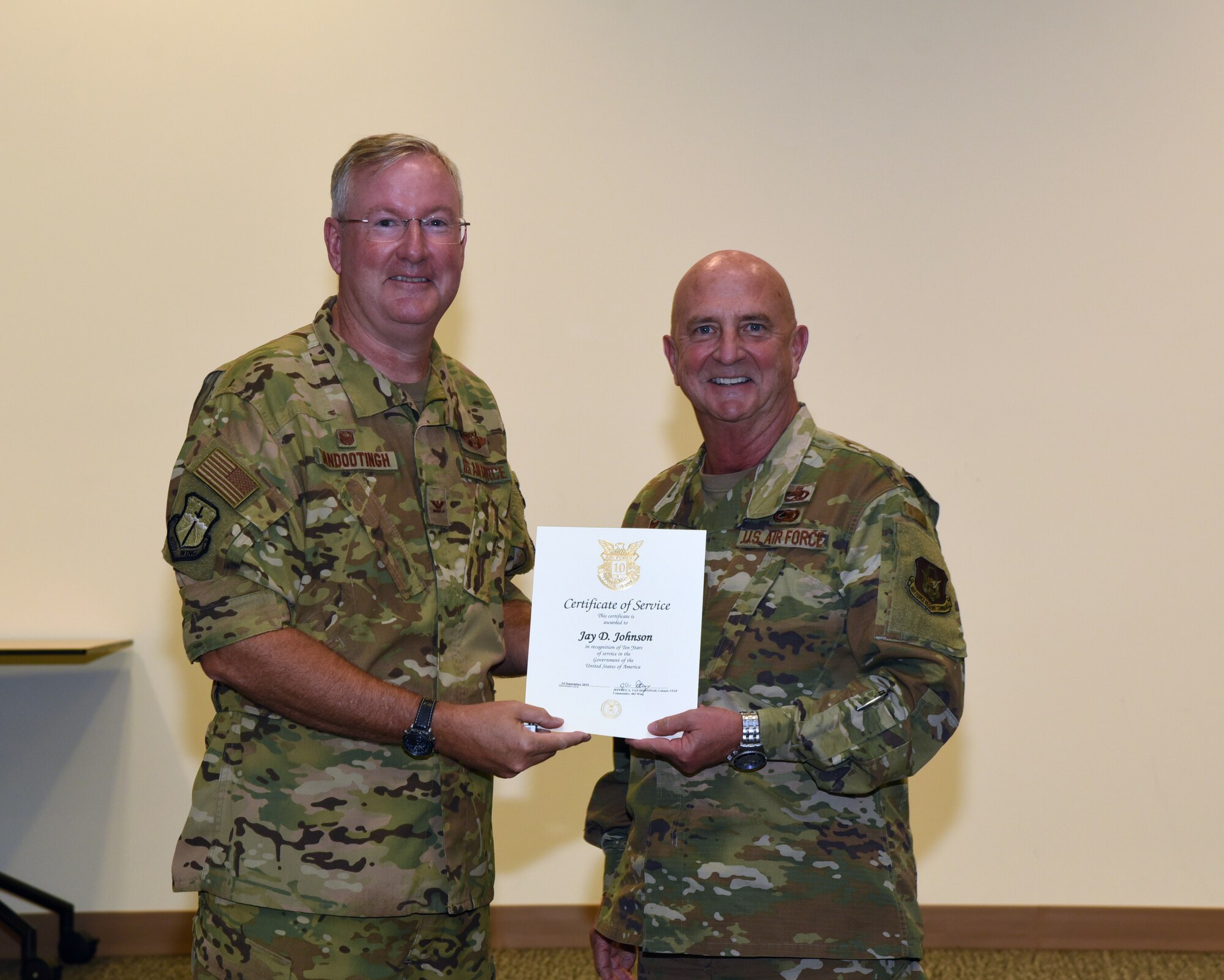 Col. Jeffery Van Dootingh, 403rd Wing commander, presented Col. Jay Johnson, 403rd Maintenance Group commander, with his 10-year service certificate as an Air Reserve Technician, Aug. 6, 2019 at the Roberts Consolidated Maintenance Facility Auditorium, Keesler Air Force Base, Mississippi.  Van Dootingh held his first civilian commanders call, where he presented service certificates and welcomed new members to the 403rd Wing. (U.S. Air Force photo by Jessica L. Kendziorek)