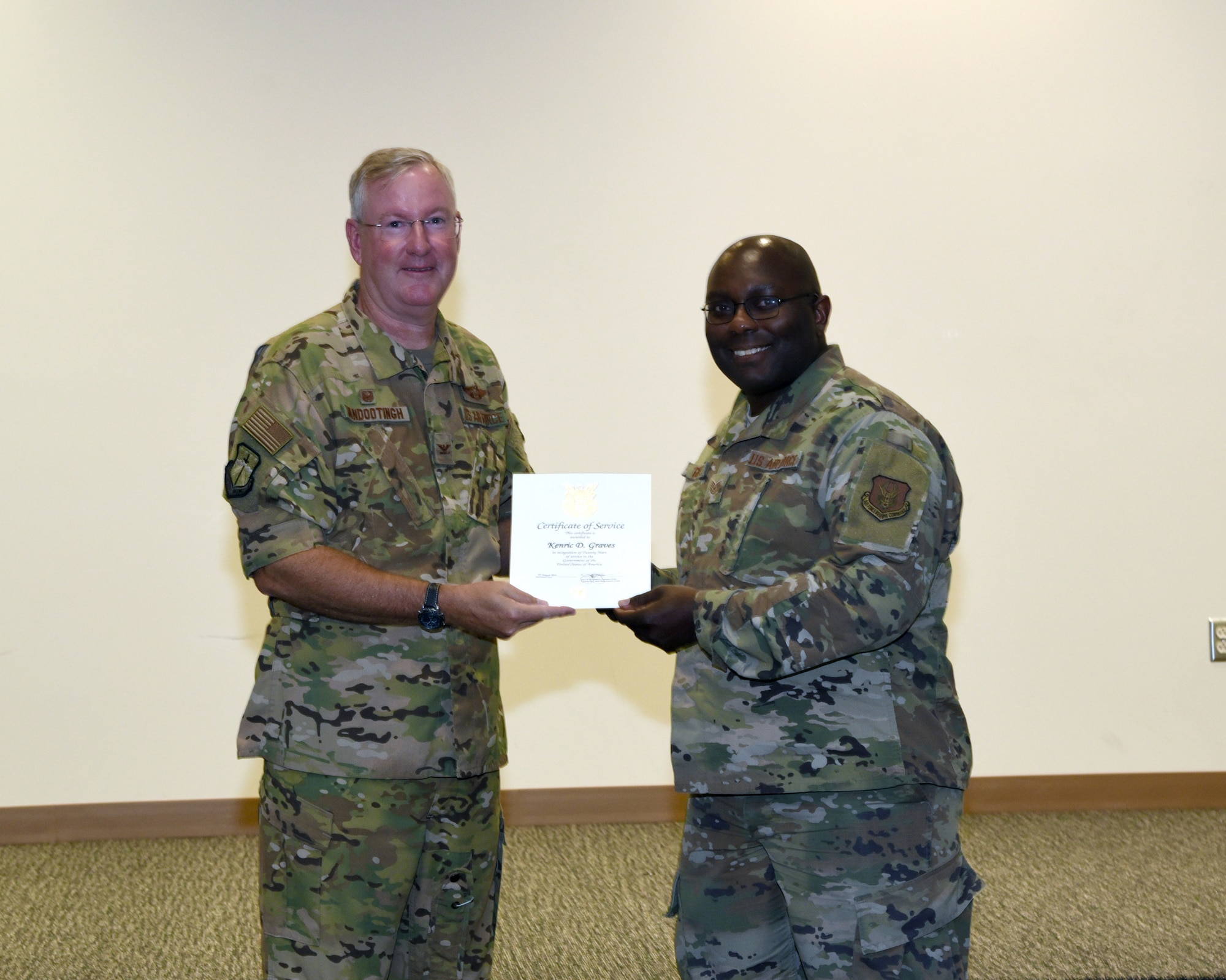 Col. Jeffery Van Dootingh, 403rd Wing commander, presented Tech. Sgt. Kenric Graves, 403rd Maintenance Squadron, with his 20-year service certificate as an Air Reserve Technician, Aug. 6, 2019 at the Roberts Consolidated Maintenance Facility Auditorium, Keesler Air Force Base, Mississippi.  Van Dootingh held his first civilian commanders call, where he presented service certificates and welcomed new members to the 403rd Wing. (U.S. Air Force photo by Jessica L. Kendziorek)
