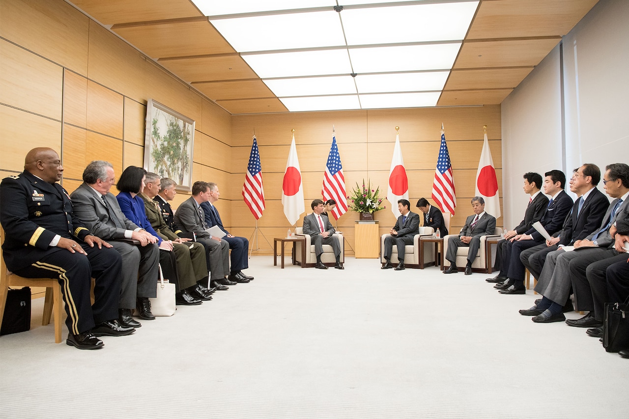 Large group of people sitting in a semicircle.