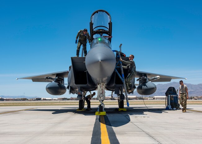 Two pilots board an aircraft.