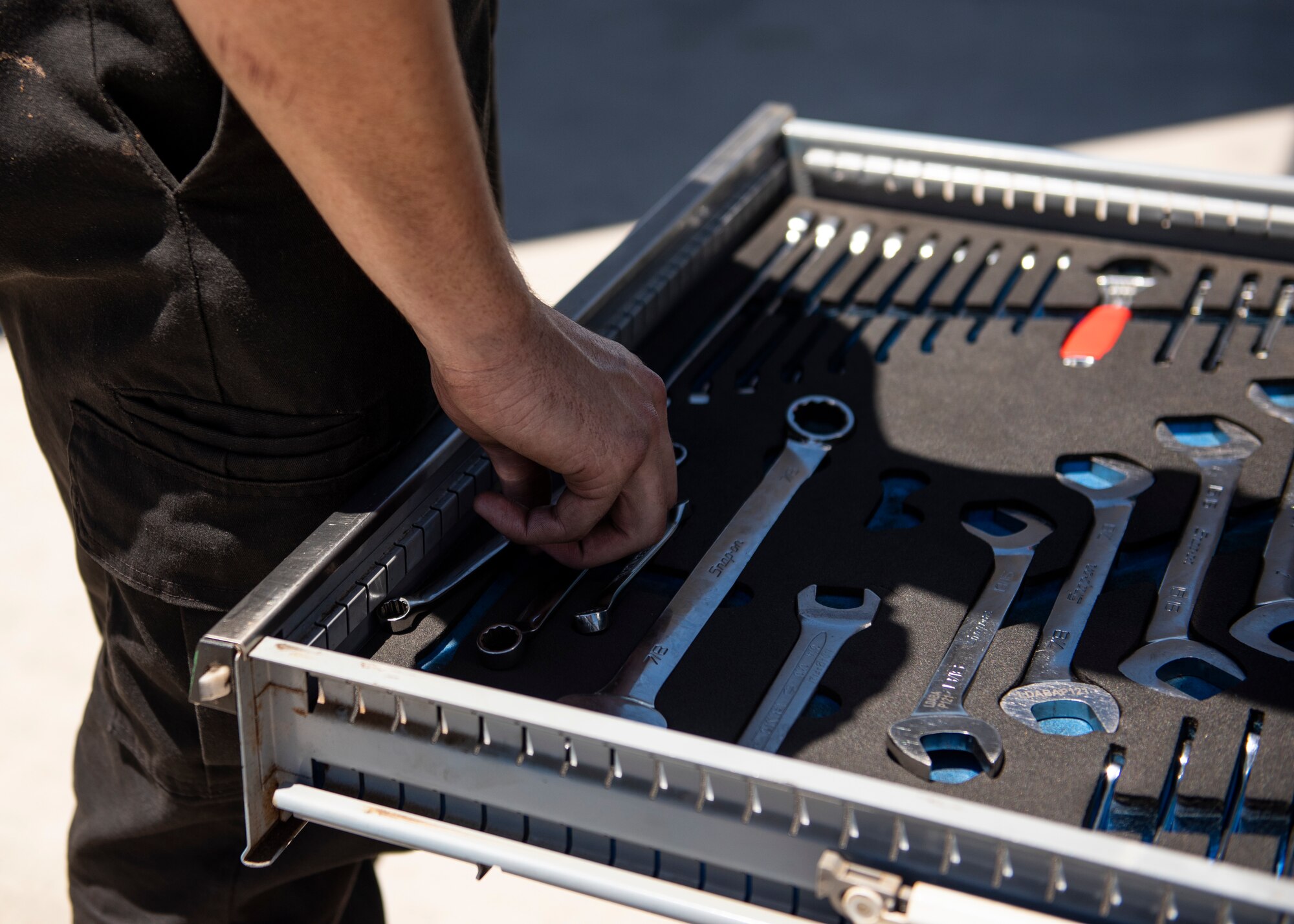 An Airman's hand reaches for a tool.