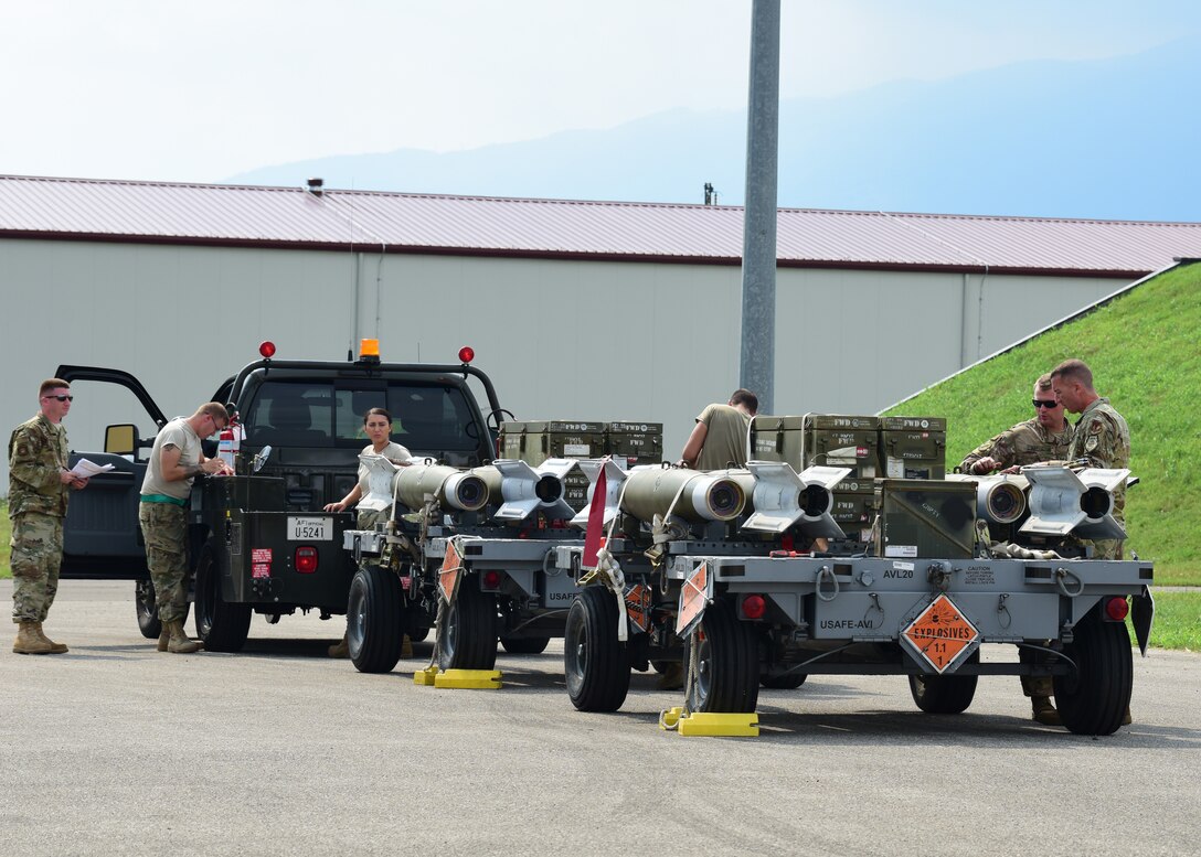 U.S. Air Force Col. Chris E. Boring, 31st Maintenance Group commander, inspects munitions with an Airman during CAPEX 2019 at Aviano Air Base, Italy, Aug. 6, 2019. Conducting exercises such as CAPEX enables Airmen to learn in a controlled environment, bolstering unit interoperability and refining their practice. (U.S. Air Force photo by Airman 1st Class Caleb House)