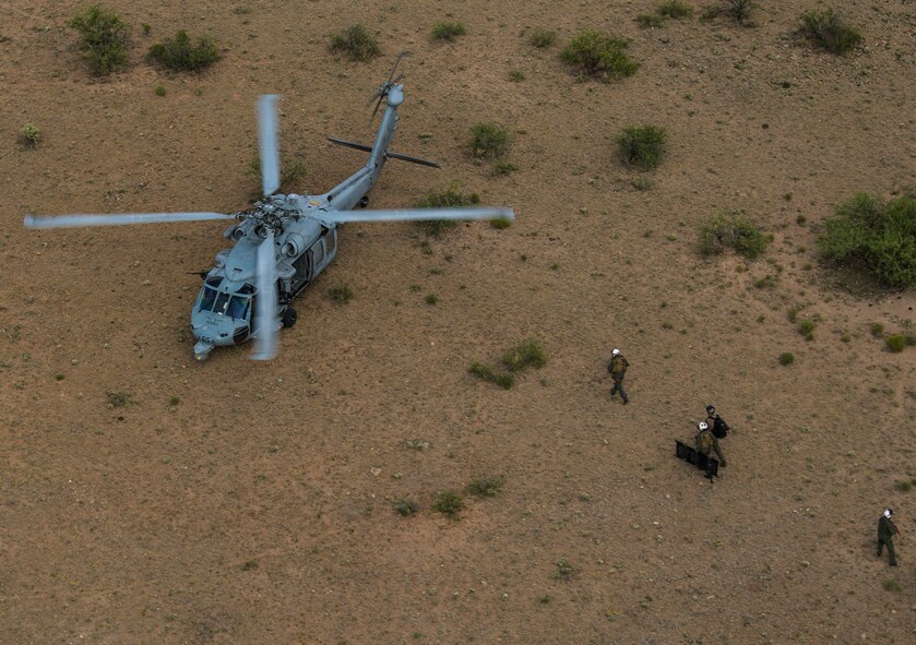 Members of a U.S. Navy MH-60S Seahawk assigned to Helicopter Sea Combat Squadron SIX (HSC-6), escort and protect an isolated person during a combat search and rescue exercise at Red Flag-Rescue 19-1, at Davis-Monthan Air Force Base, Arizona, May 7, 2019. Red Flag-Rescue gives joint service personnel an opportunity to build fundamental combat search and rescue skills to fight in and out of contested environments. (U.S. Air Force photo by Senior Airman Xavier Navarro)