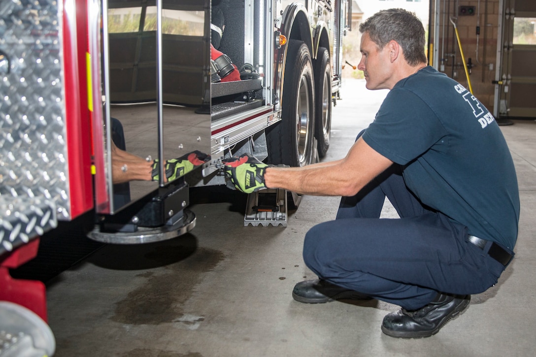 Robert Fleisher, a lieutenant paramedic with the Marine Corps Base Camp Pendleton Fire Department, performs a function check on a fire engine's air brakes during the duty change over at MCB Camp Pendleton Fire Department Station Five on MCB Camp Pendleton, California, Aug. 1, 2019. The MCB Camp Pendleton firefighters operate on 48-hour shifts, and spend the first morning of their shift assessing and cleaning vehicles and equipment to ensure mission readiness. The fire department has 11 stations on the installation and over 100 firefighters to act as first responders in the event of a fire or emergency.  (U.S. Marine Corps photo by Lance Cpl. Drake Nickels)