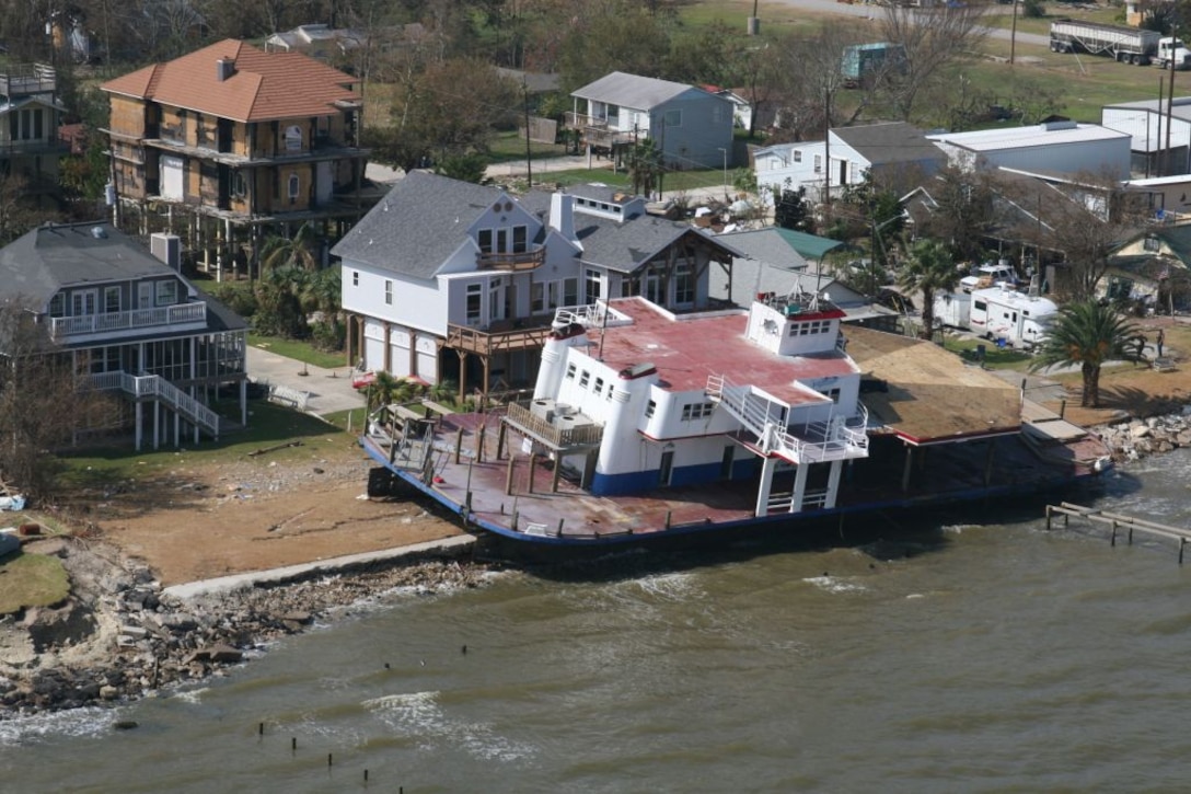 GALVESTON, Texas (September 20, 2008)—A boat is seen washed up on shore in front of a home on the coast of Galveston after Hurricane Ike made landfall September 13, 2008 as a category 2 hurricane with wind speeds of around 110 MPH. causing massive flooding and wind damage. (Photo by USACE Galveston District)