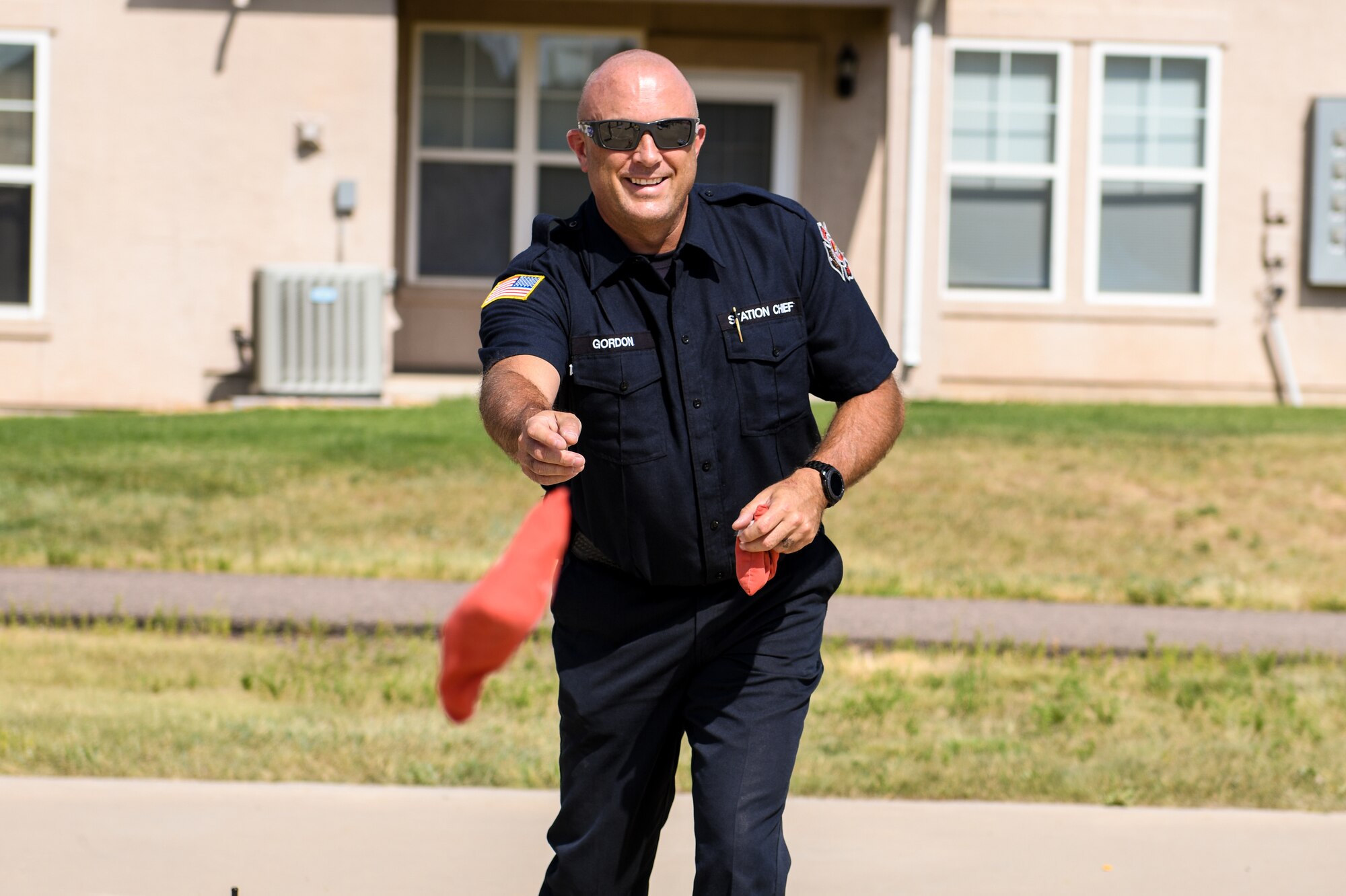 Dan Gordon, Buckley Fire Department station chief, plays cornhole at the National Night Out event, Aug. 6, 2019, on Buckley Air Force Base, Colo. The event brought the Fire Department, Security Forces and the community together.(U.S. Air Force photo by Airman Andrew I. Garavito)