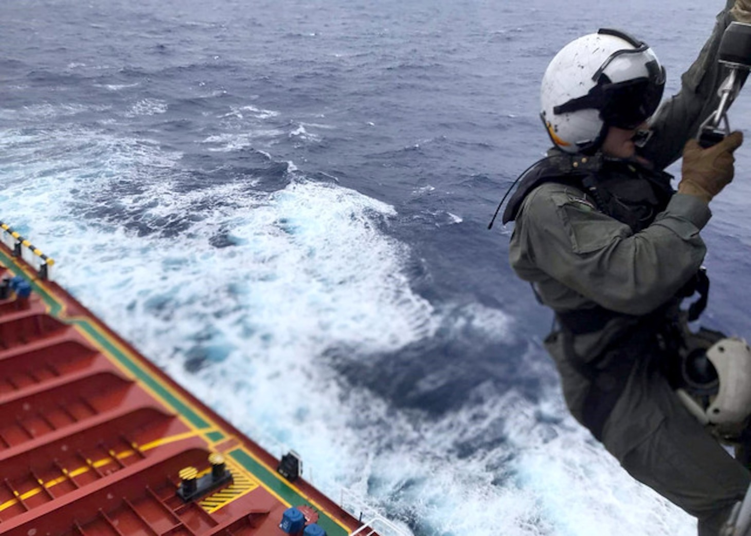 PACIFIC OCEAN (Aug. 6, 2019) Naval Air Crewman (Helicopter) 2nd Class Nathan Swartz from Elmhurst, Illinois, is lowered to the deck of Chinese-flagged vessel CSC Brave to assess a Cpatient and prepare him for movement via litter hoisting during a medical evacuation mission by the �Island Knights� of Helicopter Sea Combat Squadron (HSC) 25. The Guam-based �Island Knights� of Helicopter Sea Combat Squadron (HSC) 25 responded to the Chinese civilian in distress in the Pacific, Aug. 6.