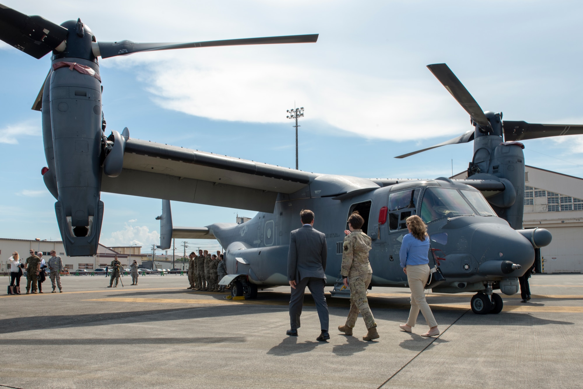 U.S. Air Force Capt. Laura Jones, 21st Special Operations Squadron flight commander, escorts Secretary of Defense Dr. Mark T. Esper and his wife Leah to meet and greet the crew of a CV-22 Osprey at Yokota Air Base, Japan, Aug. 7, 2019.