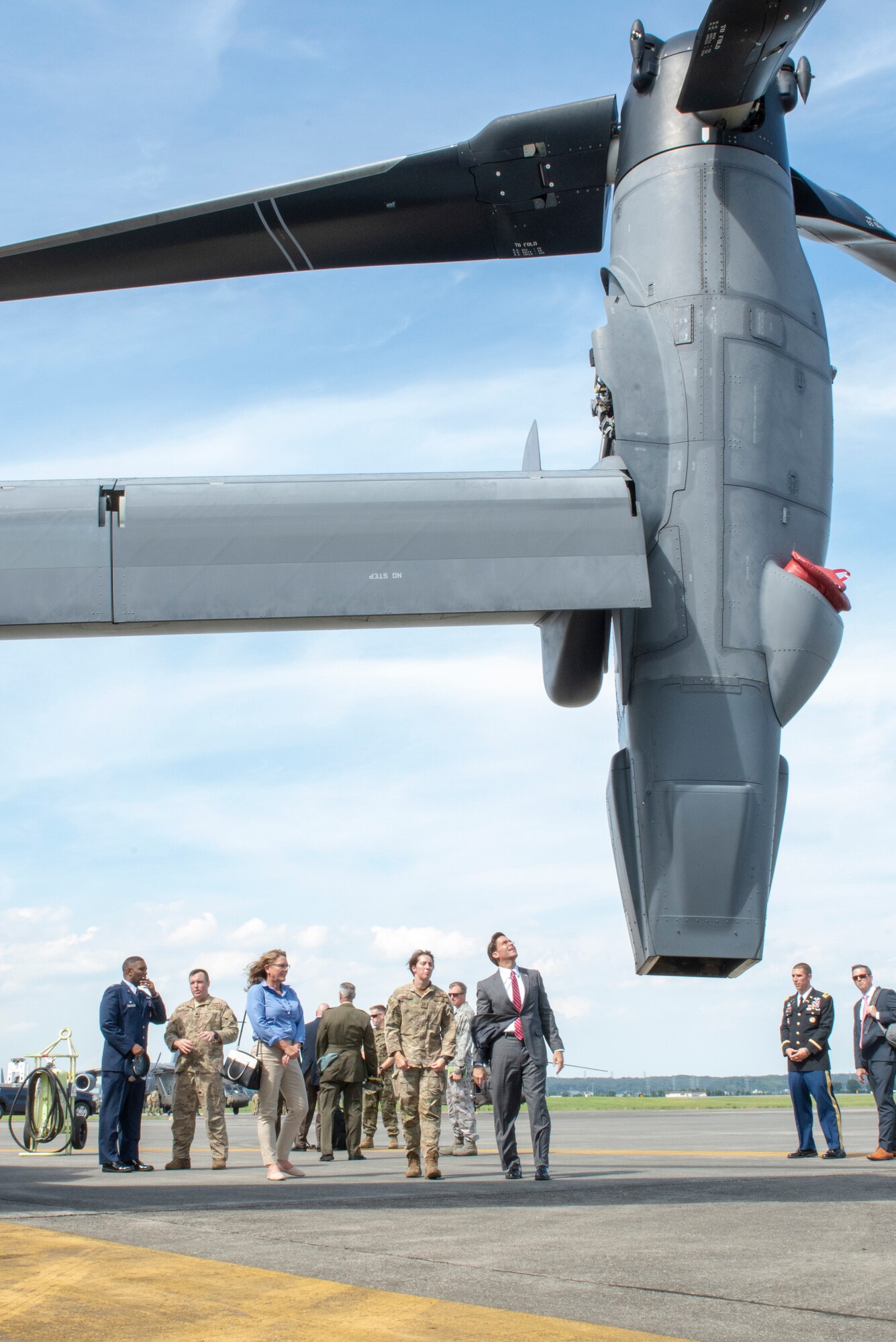 U.S. Secretary of Defense Dr. Mark T. Esper, left, looks up at the tiltrotor of a CV-22 Osprey after a troop meet and greet at Yokota Air Base, Japan, Aug. 7, 2019.