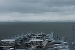 190807-N-KP021-0004 MANILA, Philippines (August 9, 2019) The aircraft carrier USS Ronald Reagan (CVN 76) anchors outside Manila, Philippines. Ronald Reagan is forward-deployed to the U.S. 7th Fleet area of operations in support of security and stability in the Indo-Pacific region.