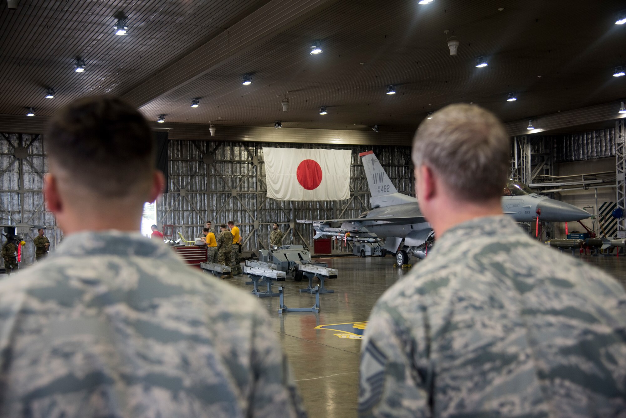 Second quarter load crew competition attendees watch 14th Aircraft Maintenance Unit Airmen gather around a work station during the event at Misawa Air Base, Japan, Aug. 2, 2019. The event gave Airmen an opportunity to perform their munition loading skills to the best of their abilities for an audience while racing against the maximum allotted time clock of 22 minutes.
(U.S. Air Force photo by Takaharu Daibo)