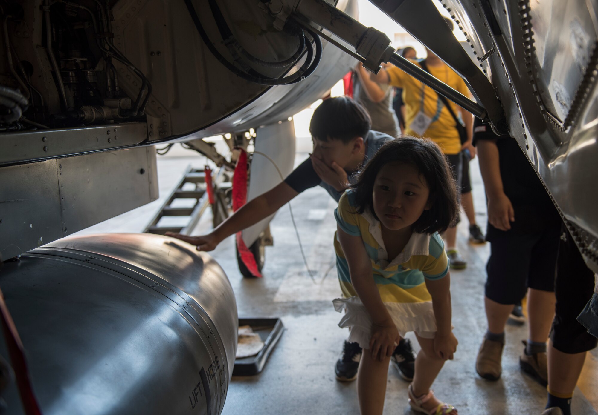 Korean children from the local area examine an F-16 Fighting Falcon during a tour at Kunsan Air Base, Republic of Korea, Aug. 2, 2019. The tour ended with the children getting up close and personal with one of the 8th Fighter Wing’s aircraft, and a demonstration from the 8th Aircraft Maintenance Squadron on loading the F-16. (U.S. Air Force photo by Senior Airman Stefan Alvarez)