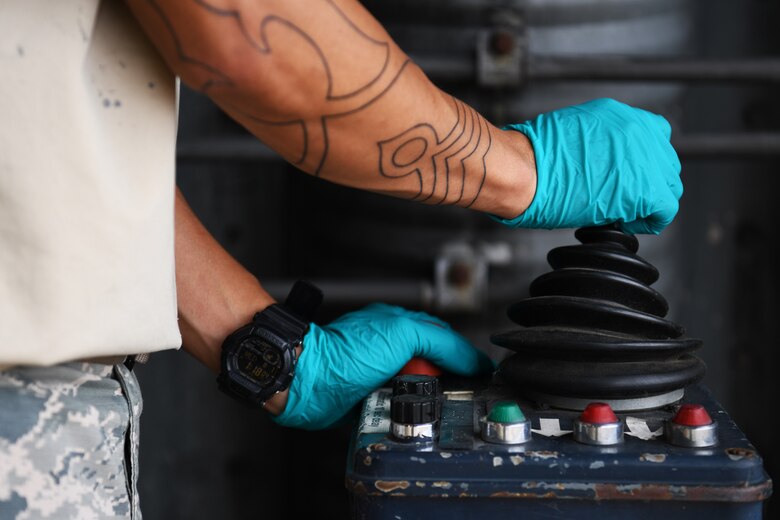 U.S. Air Force Senior Airman Matthew Bonjoe Rosario, 48th Civil Engineer Squadron structural apprentice, operates the door mechanism of a protected aircraft shelter at Royal Air Force Lakenheath, England, Aug. 7, 2019. The 48th CES Airmen perform monthly maintenance on each PAS to ensure their readiness and prolong their lifespan. (U.S. Air Force photo by Airman 1st Class Shanice Williams-Jones)