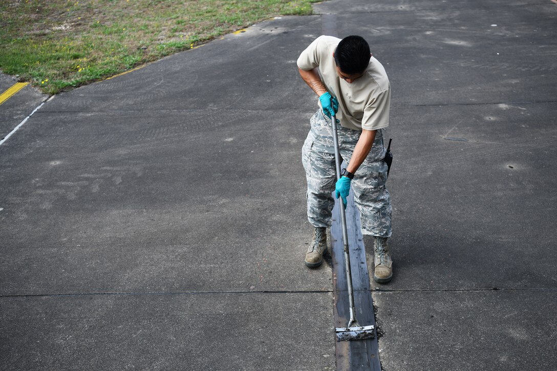 U.S. Air Force Senior Airman Matthew Bonjoe Rosario, 48th Civil Engineer Squadron structural apprentice, prepares a protected aircraft shelter for maintenance at Royal Air Force Lakenheath, England, Aug. 7, 2019. The 48th CES Airmen perform monthly maintenance on each PAS to ensure their readiness and prolong their lifespan. (U.S. Air Force photo by Airman 1st Class Shanice Williams-Jones)