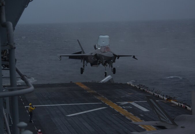 An F-35B Lightning II fighter aircraft with Marine Medium Tiltrotor Squadron 265, 31st Marine Expeditionary Unit, lands after dropping a Joint Direct Attack Munition and a laser guided bomb during an aerial gunnery and ordnance hot-reloading exercise aboard the amphibious assault ship USS Wasp, Solomon Sea, August 4, 2019. Wasp, flagship of the Wasp Amphibious Ready Group, with embarked 31st MEU, is operating in the Indo-Pacific region to enhance interoperability with partners and serve as ready-response force for any type of contingency, while simultaneously providing a flexible and lethal crisis response force ready to perform a wide range of military operations.