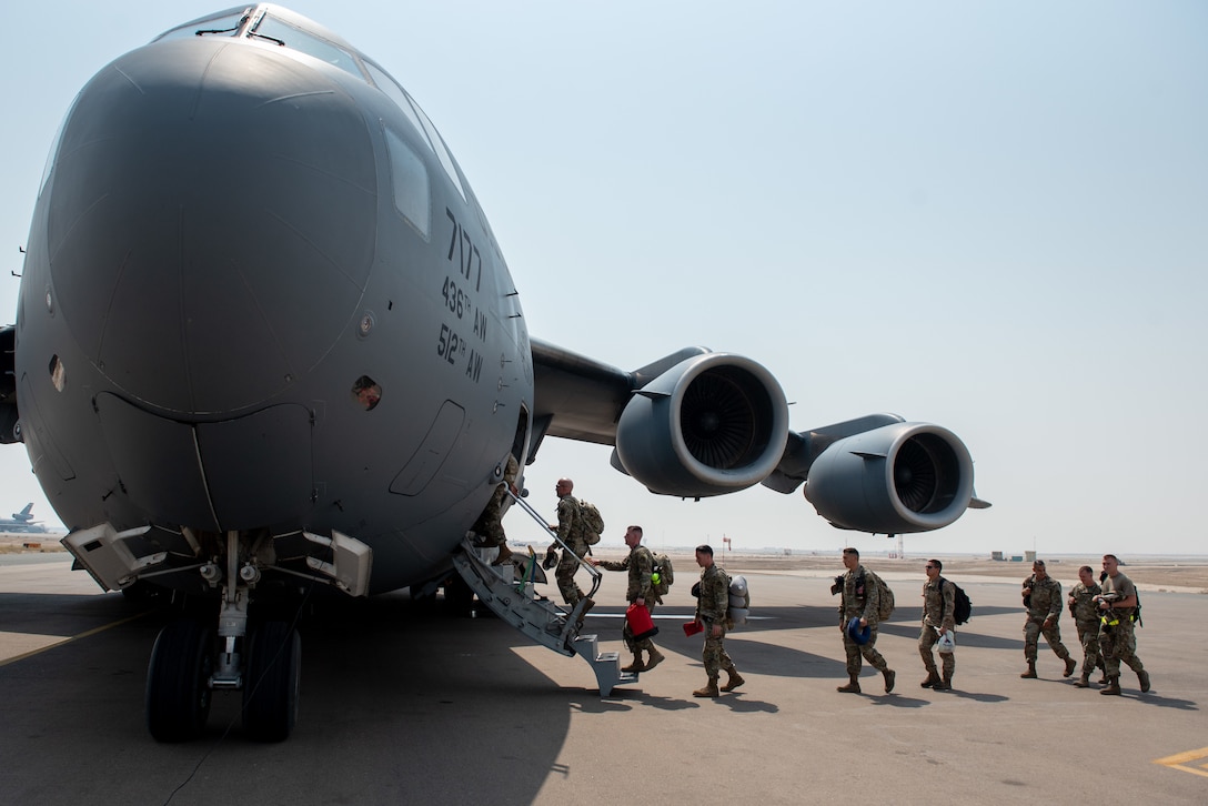 A photo of Airmen boarding a C-17