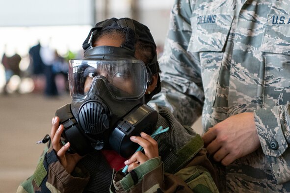 A military child participates in a Kids Deployment Line.