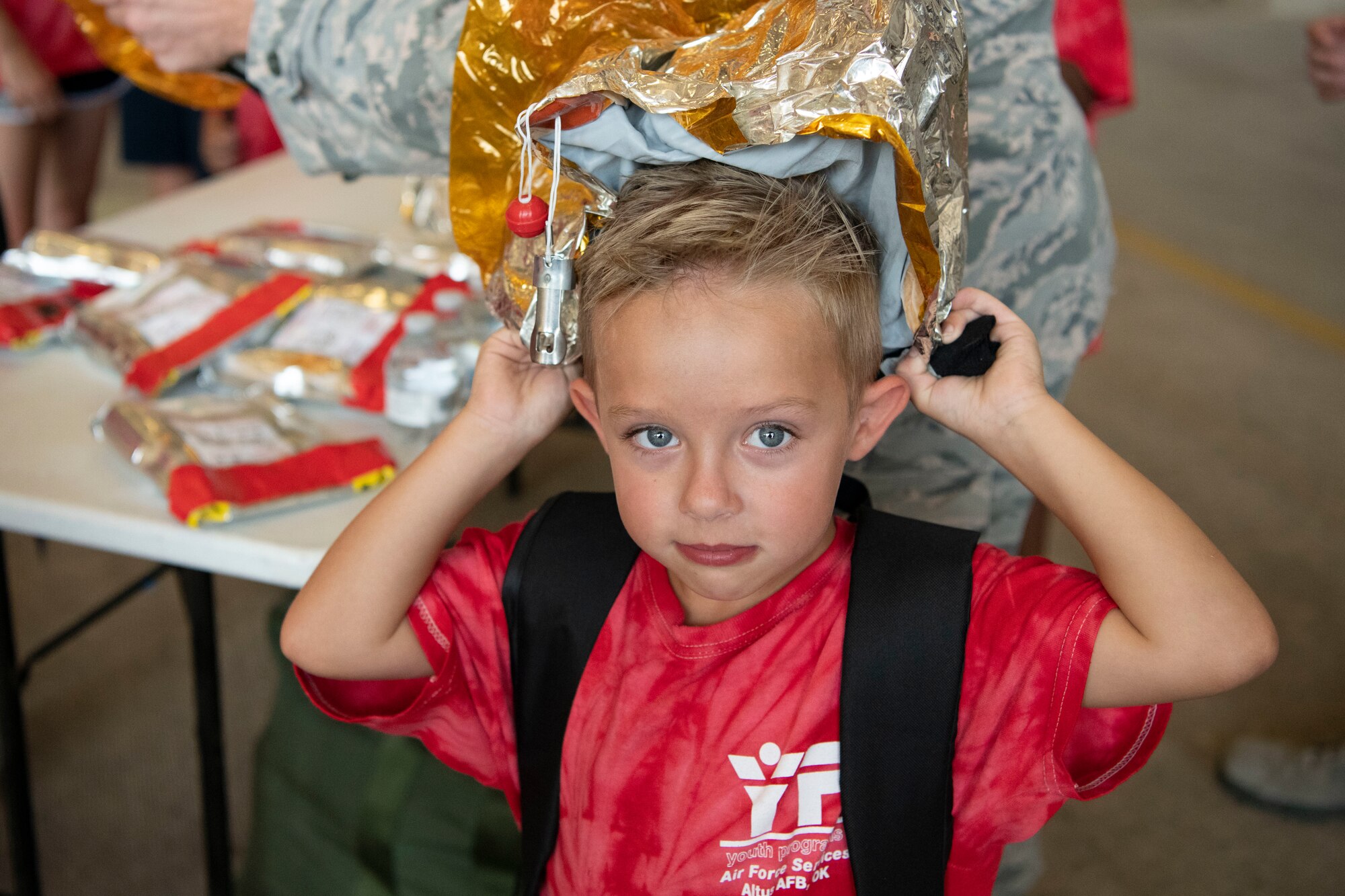 A military child participates in a Kids Deployment Line.