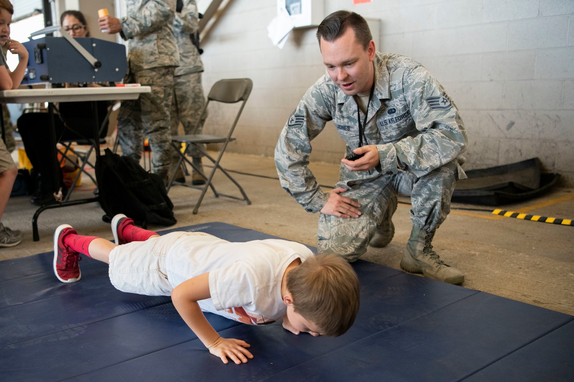 A military child participates in a Kids Deployment Line.