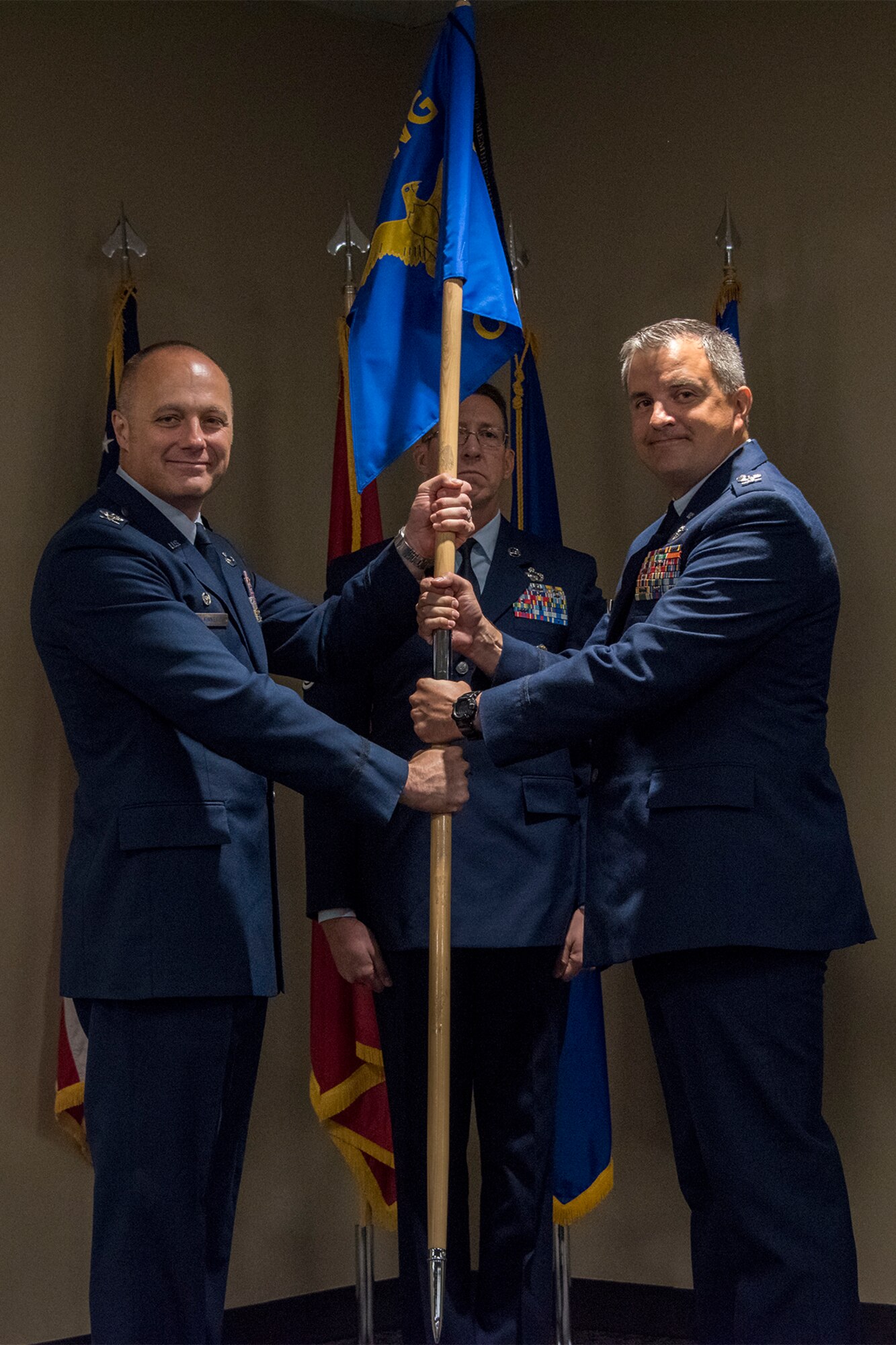 Col. Robert I. Kinney, 188th Wing commander, passes the 188th Operations Group guidon to Col. Patric D. Coggin, 188OG commander, during a change of command ceremony August 7, 2019, at Ebbing Air National Guard Base, Ft. Smith, Arkansas. Coggin assumed command of the group from Col. Jeremiah S. Gentry, who will be promoted to the position of wing vice commander during the wing’s August 2019 unit training assembly. (U.S. Air National Guard photo by Tech. Sgt. John E. Hillier)