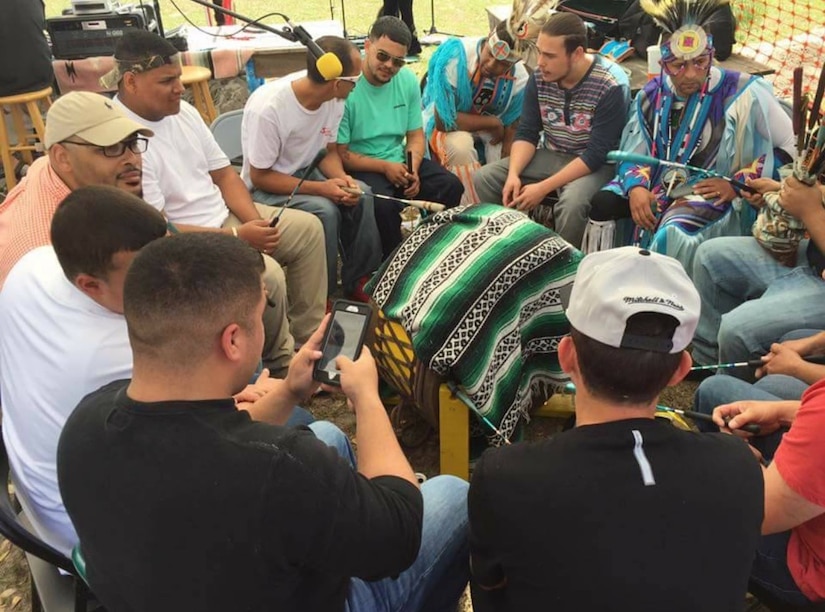 Members of the Edisto Natchez-Kusso Tribe play on the southern drum during a powwow with U.S. Army Specialist Nathan Creel, an animal care specialist assigned to the Charleston Veterinary Treatment Facility, at Mt. Dora, FL, March, 2016.