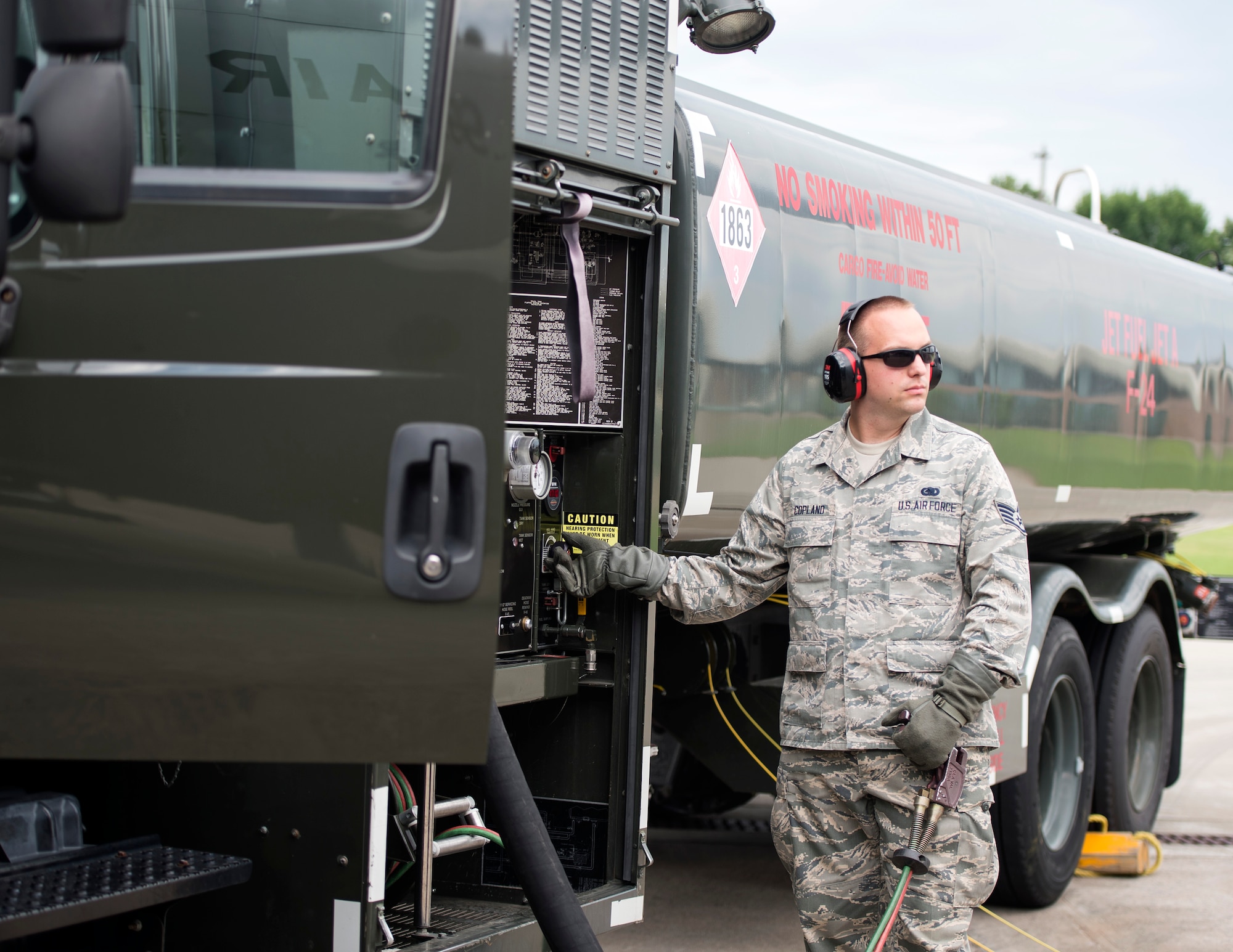 U.S. Air Force Staff Sgt. Andrew Copland, a fuels specialist with the 133rd Petroleum, Oil and Lubricants Flight, controls the fuel flow with the dead man handle while servicing the C-130 Hercules in St. Paul, Minn., July 18, 2019.